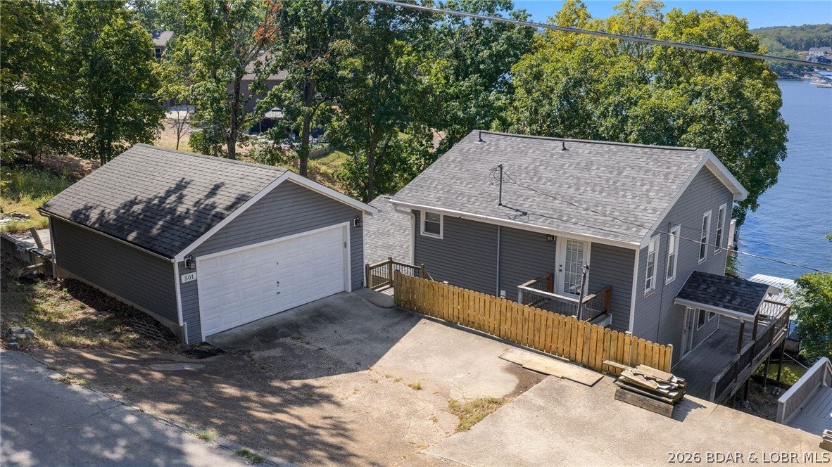Looking for a deal on a lakefront home with 100 feet of shoreline? Wanting to be in a great location by land and water?  If so, we have the property for you! This home is in Linn Creek on the 30MM of the beautiful Lake of the Ozarks. This home offers main channel views with some protection on a large double lot. Features 3 bedrooms and 2 bathrooms and a 2 car detached garage. It’s priced right so you have room to make the house your own and update the dock to fit your needs with the large dock envelope and year-round deep water. All paved roads to the house. Situated on a .40-acre lot, this property offers the freedom and space to make it your own. Whether you're searching for a full-time lake home or weekend retreat, this is your chance to enjoy lakefront living.