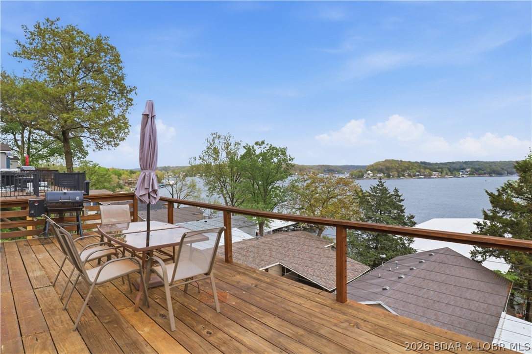 Wake up to beautiful lake sunrises at this turnkey retreat on the Gravois Arm at the 4-mile marker of Lake of the Ozarks. This renovated 2-bedroom, 2-bath home offers just over 1,000 square feet of comfortable lake living w/ modern upgrades, wonderful views, & easy access to your boat slip just a short walk away. Step inside to find LVP flooring throughout & a thoughtfully updated interior designed for easy maintenance & relaxed lake living. The kitchen features a newer gas stove & modern finishes, while the open layout provides a welcoming space for gathering with family & friends after a day on the water. A newer HVAC system provides year-round comfort, and smart home features—including a wireless thermostat and keyless entry—add convenience whether you’re arriving for the weekend or heading out on the lake. Outside, the newly rebuilt deck offers the perfect place to enjoy morning coffee while taking in peaceful lake views and stunning sunrises. With quick & easy access to your boat slip, getting out on the water is effortless. With modern renovations, incredible lake views, & a welcoming atmosphere, this turnkey property is the perfect weekend lake family getaway.