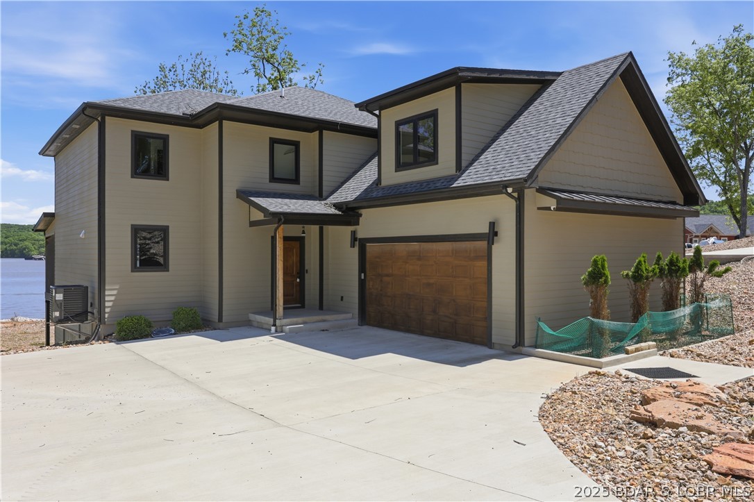 OPEN SATURDAY AND SUNDAY JUNE 27-28 1-4 pm New Construction with Dock! Spectacular Views from the covered deck! Just in time for Summer on the lake!  Custom-built three-story home offers over 4,000 sq. ft. of living space, featuring 5 bedrooms with an additional non conforming room could be used as a bedroom and 4.5 baths designed with comfort and style in mind. The main level is perfect for everyday living, showcasing a chef’s kitchen with quartz countertops, dual ovens, a walk-in pantry, and an oversized island that makes entertaining a breeze. Take in the gorgeous lake views from your screened-in deck, or head downstairs to the spacious second living area complete with a wet bar, all walking out to a stamped concrete patio and a wide-open lake yard—perfect for fire pits, games, and gatherings. With a two-car garage and plenty of room for family and friends, this home has it all. From high-end finishes to thoughtful design. Dock has 2 boat slips, 2 covered wave runner slips, 2 storage sheds, Water steps, electrical and lights. Huge covered seating area and large open swim area, dock will be installed in July. Home is not in a flood plain. Fema letter in supplements states that.