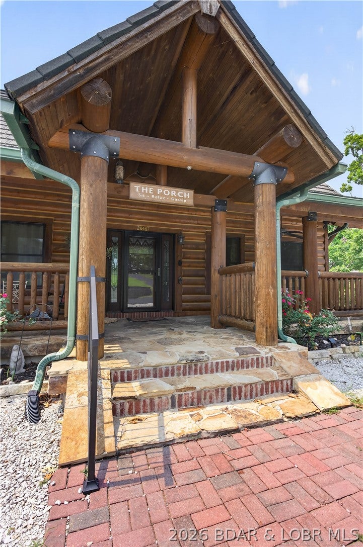Luxury log home living awaits in one of the area’s most sought-after lake subdivisions! Located right next door to Long Shoal Marina, this exceptional 3-bedroom, 2.5-bath custom log home offers timeless craftsmanship, high-end finishes, and an unbeatable location just up the road from the community boat ramp while enjoying convenient access to shopping, dining, and all the amenities of town, just minutes away. Step inside and be greeted by soaring ceilings, stunning exposed log beams, and an impressive floor-to-ceiling stone wood-burning fireplace that anchors the spacious great room. Expansive windows flood the home with natural light. The custom-designed kitchen is truly the heart of the home, featuring beautiful cabinetry, quality finishes, generous workspace, and an open-concept design ideal for entertaining family and guests. Two detached garages offer abundant room for vehicles, boats, recreational toys, and workshop space. Whether you’re searching for a luxurious full-time residence or the ultimate lake retreat, this remarkable property offers the perfect combination of rustic elegance, modern convenience, and exceptional craftsmanship.