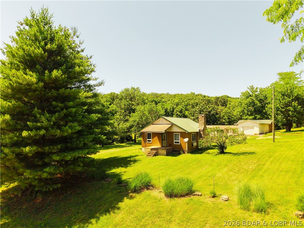Unique 5-acre property at the edge of Laurie, just a half mile off Highway 5. Featuring over 3,500 square feet of combined space, this property includes a remodeled 2-bed, 1-bath farmhouse with updated wiring, windows, doors, flooring, pellet stove, and PTAC unit. Also included is a framed and roofed 2-bed, 1-bath new construction home with attached garage, concrete floors, plumbing and ductwork already in place. A third cinder block building offers additional potential, while the extra-deep 960 sq ft detached garage provides excellent storage or workshop space. Survey completed. Mostly open, well-maintained acreage with endless possibilities for multi-generational living, rental income, or future expansion.