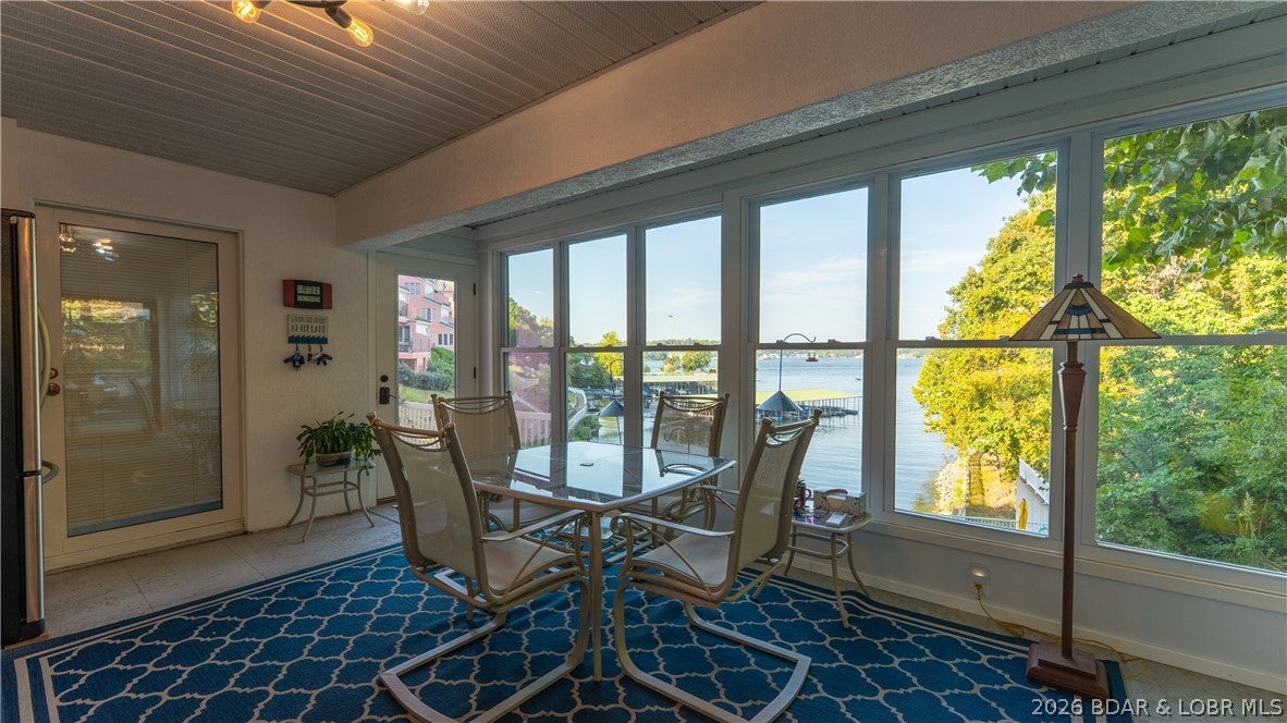 Breathtaking Main Channel Views & Unmatched Convenience at Beach Club! This beautifully updated 3BR, 2BA end-unit condo offers approximately 2,150 sq ft of spacious living in a private and secluded setting. What truly sets this condo apart is its exceptional accessibility—NO STEPS to the unit! In fact, this is the only unit in the complex where you can golf cart directly to your door. Even better, you can golf cart directly from your condo to your boat slip, making lake days effortless. Enjoy breathtaking main channel views from this one-of-a-kind property. This is also the only unit in the complex featuring a climate controlled Four Seasons room providing a beautiful year-round space to relax, entertain, or take in the stunning lake views. The spacious floor plan, tasteful updates, end-unit location, and surrounding privacy create the perfect lake retreat. A garage provides additional convenience and storage. Boaters will love the included 14' x 36' boat slip and easy golf-cart access. With features found nowhere else at Beach Club, this condo is truly a rare Lake Ozarks gem!