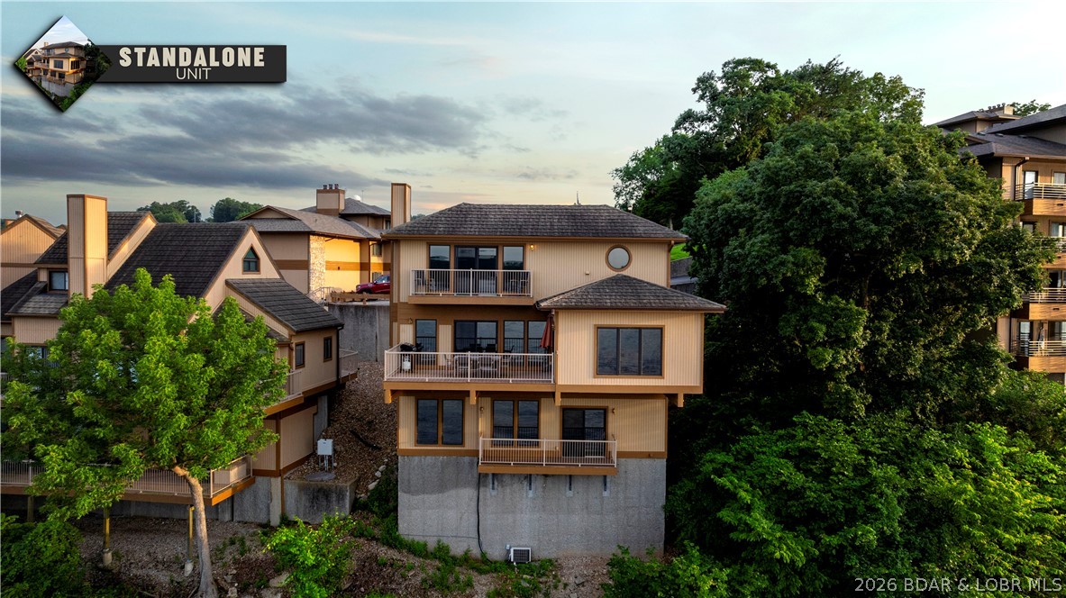 Experience the rare opportunity to own a stand-alone villa in The Breakers Condo Complex in Lake of the Ozarks. Offering privacy with no neighbors above, below, or on either side while still enjoying the outstanding amenities of the community, including a lakeside pool and tennis courts. Floor-to-ceiling windows showcase breathtaking lake views and fill the home with natural light, creating a warm and inviting atmosphere. Being sold fully furnished and turnkey, this villa is ready for you to begin enjoying Lake of the Ozarks from day one. The sale includes a coveted 16x40 cruiser boat slip on the protected side of the community dock, plus a PWC slip, making it the perfect setup for boating enthusiasts. Ideally located at the 3 Mile Marker, you'll love spending evenings taking in some of the lake's most spectacular sunset views. Love the peace and quiet with a neighborhood that doesn't allow short term rentals. Call for a private showing today!