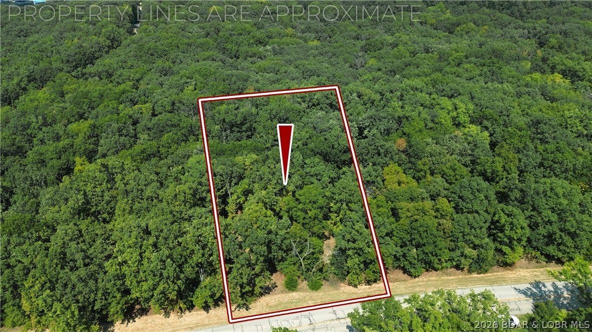 An affordable opportunity to own in Porto Cima! This off water lot offers a great combination of location, usability and value in one of Lake of the Ozarks' most desirable communities. The relatively flat terrain should make building easier than many Lake-area lots, and water and sewer are available for connection. Even better, the property backs to Four Seasons POA-owned ground, giving you a great neighbor with no home directly behind you. This area of Porto Cima has experienced tremendous growth in recent years with attractive new construction and spec homes throughout the neighborhood. Four Seasons amenities are another big bonus, with a community pool, tennis courts and more just a short walk away. Additional membership opportunities are available for golf, marina access and other amenities. Whether you're ready to build now or simply want to secure a reasonably priced lot for the future, this is a great way to get into Porto Cima without a big investment. Nice lot, great community, available utilities and an attractive price—bring your plans and start building!
