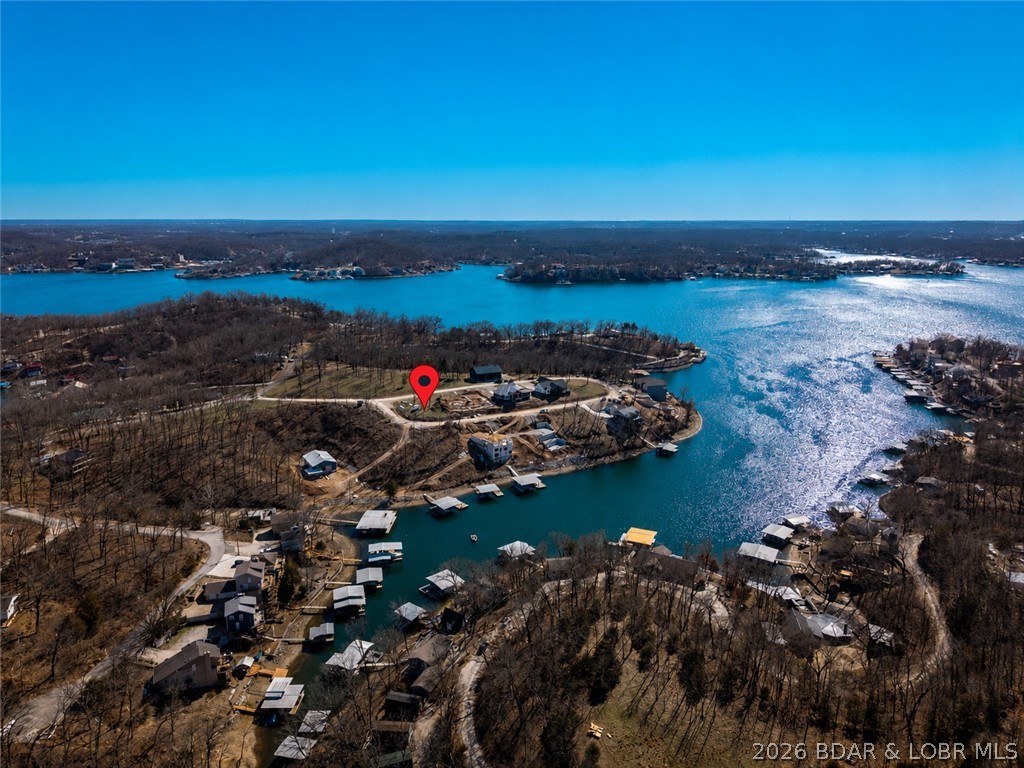 Positioned at the entrance of Los Breezes, this premium corner lot offers an exceptional opportunity to build your dream home in one of Lake of the Ozarks' newest developments. Enjoy beautiful lake views overlooking the renowned 6-mile marker of the Osage Arm, providing the perfect backdrop for lake living. This build-ready homesite combines a highly desirable location with the convenience of established infrastructure, including community water service and access to the Rocky Mount Sewer District. Situated near the front of the subdivision, the property offers easy access while maintaining the charm and appeal of a thoughtfully planned lake community.