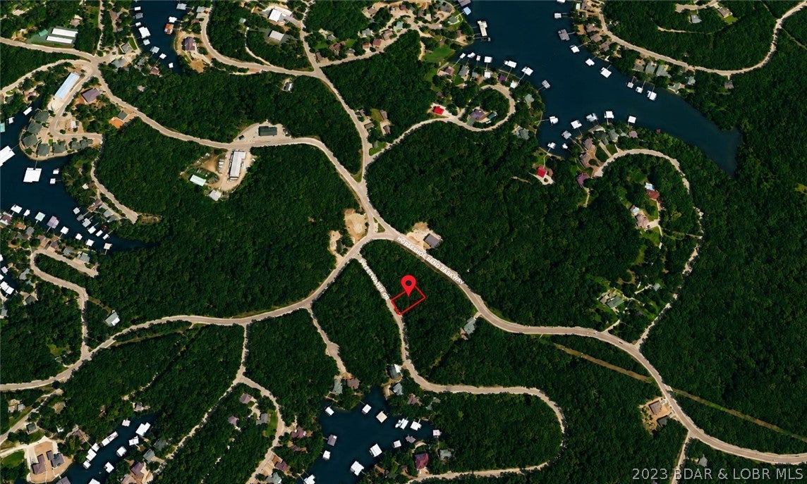 Build your dream home at the beautiful Lake of the Ozarks on this exceptional lot. Positioned in a prime location and surrounded by the area's natural beauty, you can create a haven that perfectly complements your lifestyle. Enjoy the convenience of nearby amenities and recreational activities such as swimming pools, walking/bike paths, playground basketball, tennis and more. This affordable lot has much to offer!. Don't miss out on claiming your own piece of paradise at the Lake of the Ozarks.