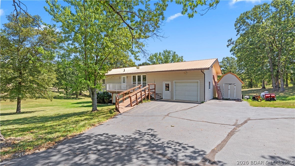 Welcome to 2893 State Road V in Linn Creek! This spacious home offers five bedrooms, including one nonconforming bedroom, three bathrooms, two full kitchens, and two separate living areas. The versatile lower level can function as a private apartment, guest suite, or multigenerational living space, offering excellent potential for additional rental income. With plenty of room to spread out and a flexible layout designed to fit a variety of needs, this property is ideal for a large household, extended family, or an investment opportunity. Schedule your showing today and discover all the possibilities this unique home has to offer!