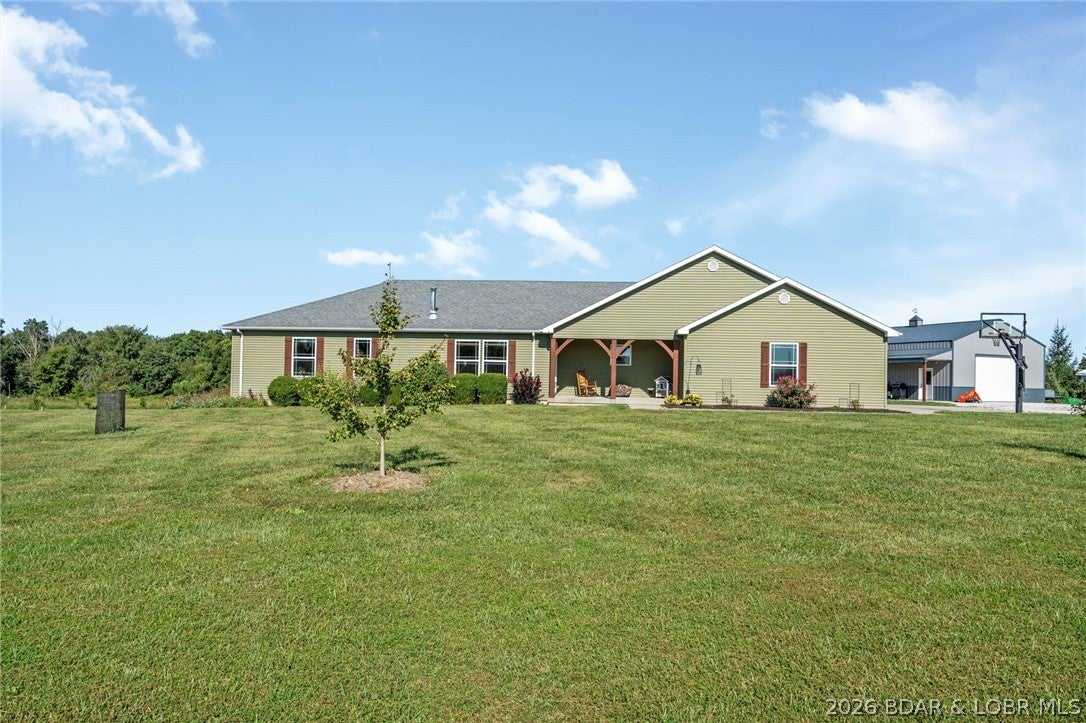 PEACEFUL COUNTRY LIVING MEETS CUSTOM CRAFTSMANSHIP ON 10.3 ACRES! This one-of-a-kind property offers the space, quality & versatility that are increasingly hard to find. The main level features beautiful custom craftsmanship, hand-built kitchen cabinetry, doors & trim, quartz countertops, pantry. Geothermal heating & cooling provide year-round efficiency, while the wood-burning fireplace adds warmth & character. The finished lower level has a CONFORMING BEDROOM, full bath, walk-in closet. You'll also find a unique secure VAULT ROOM that can be locked and unlocked from the inside and offers versatility as a panic/safe room as well as protection during severe weather. Step outside and you'll quickly see this property was designed for more than just having acreage. Fenced areas provide room for animals, while the garden area is already SET UP FOR IRRIGATION. An orchard features approximately 40 fruit/nut trees, including apple, pear, cherry, & peach trees, along with young pecan & almond trees. Then there's the SHOP! More than simply an outbuilding, it is equipped w/electric heat & window A/C  & is already wired to accommodate a future HVAC. Come see what makes it special!