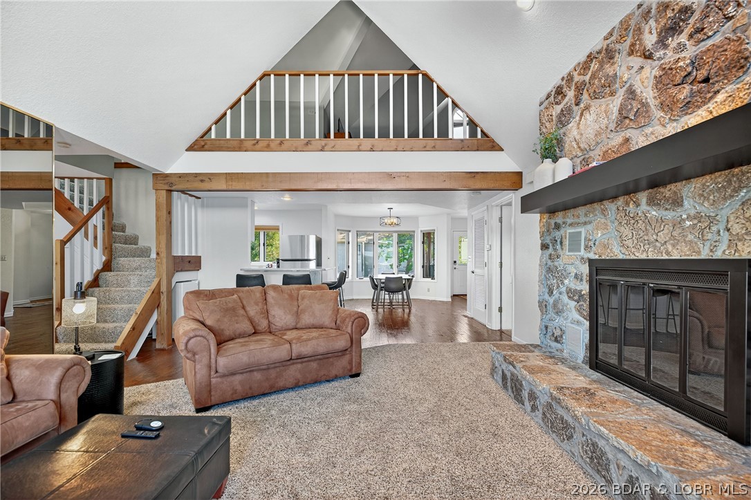 Top-floor living at Summerset Condominiums blends thoughtful updates with classic Lake of the Ozarks charm. With over 2,100 square feet, the main living area features vaulted ceilings, a striking stone fireplace (inoperable), and direct access to the lakeside deck. The kitchen has been refreshed with stainless appliances, solid surface countertops, and bright cabinetry, opening into the dining space. The primary suite offers private deck access and jetted tub, while a guest bedroom and full bath complete the main level. Upstairs, the oversized loft currently serves as the third bedroom with its own full bath and additional storage. The lakeside deck is made for relaxing, with extra storage and an elevated second-tier view that speaks for itself. Offered furnished for immediate enjoyment. Summerset Villas is a boutique 14-unit community featuring a lakeside pool, peaceful cove setting, and welcoming atmosphere. Spend your days on the water, fishing nearby, or take a short walk to Dog Days Bar & Grill. Prefer a night in? The clubhouse offers a full kitchen, conference space, pool table, and more. Boat slip may be leased from Gozark Resort formerly Summerset next door.