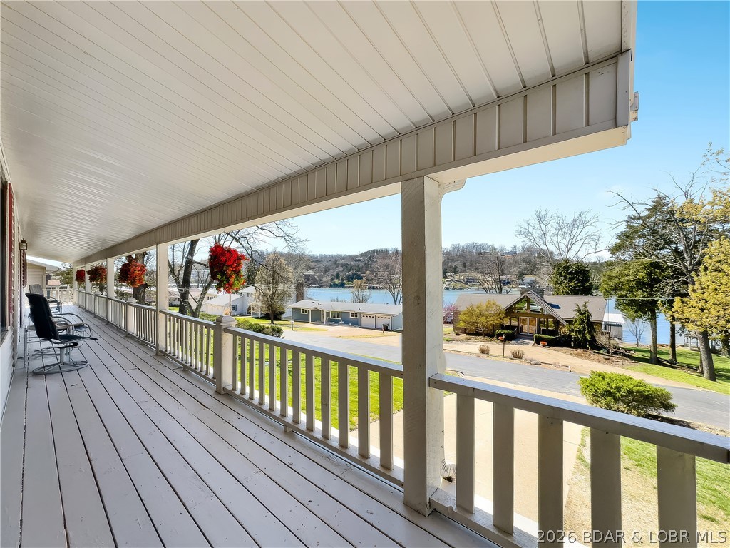 Phenomenal view of the lake from this 4-bedroom 3-bath home in desirable Normac Estates just off Hwy 54 in Camdenton, MO. Just across the bridge are two of the lake's premier golf courses and several restaurants. This well-cared-for home has a new roof, HVAC system, windows, and sliding doors. Covered front porch and a screened-in porch so you can comfortably sit and look out over the lake to watch the activity or just to watch the sunset. A 10x24 dock slip in the community dock, just a block or so away, is included. Black-topped roads throughout the subdivision. This is a truly must-see home. Call to set up your private showing before this one gets away. Interior pictures coming soon.