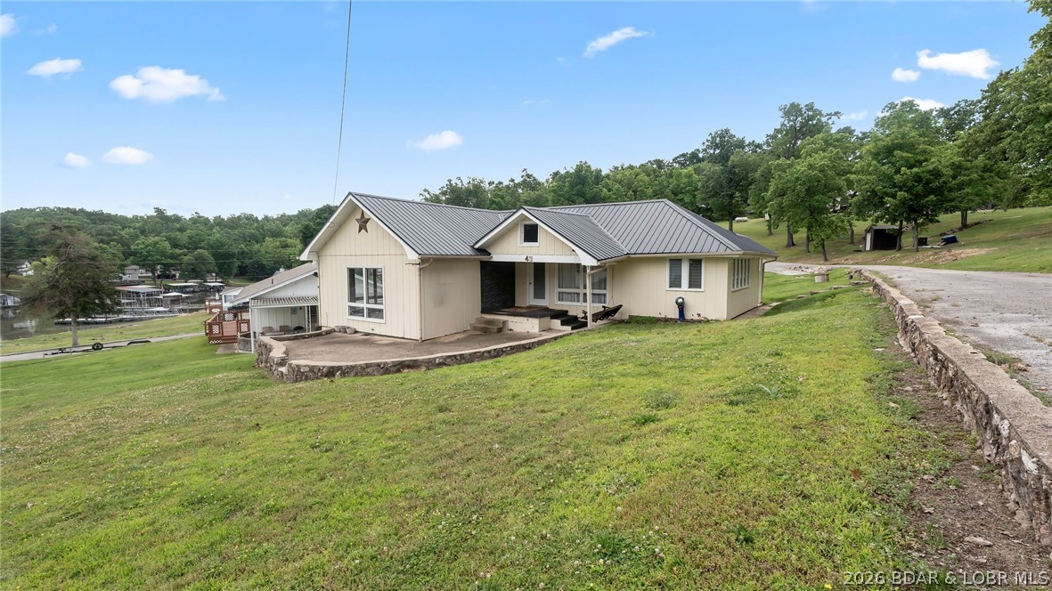 Charming 3-bedroom, 1-bath cabin offering all main-level living and the perfect lake lifestyle! This move-in-ready home features a cozy electric fireplace , creating a warm and inviting space to relax after a day on the water. The community is also developing a golf cart parking area and path, making it even easier to enjoy the neighborhood and waterfront amenities. Included with the property is your own 10x24 boat slip, making lake access easy and convenient. Located at the popular 8 MM in Buck Creek Cove near Shady Gators and Camden on the Lake, you’ll be just minutes from waterfront dining, entertainment, and all the excitement Lake of the Ozarks has to offer. From the road, you are right across from Bear Bottom Resort.  This is a perfect investment opportunity whether you're looking add an additional nightly rental to your portfolio, or for incredible 2nd home living opportunities. Call now to schedule your private showing!
