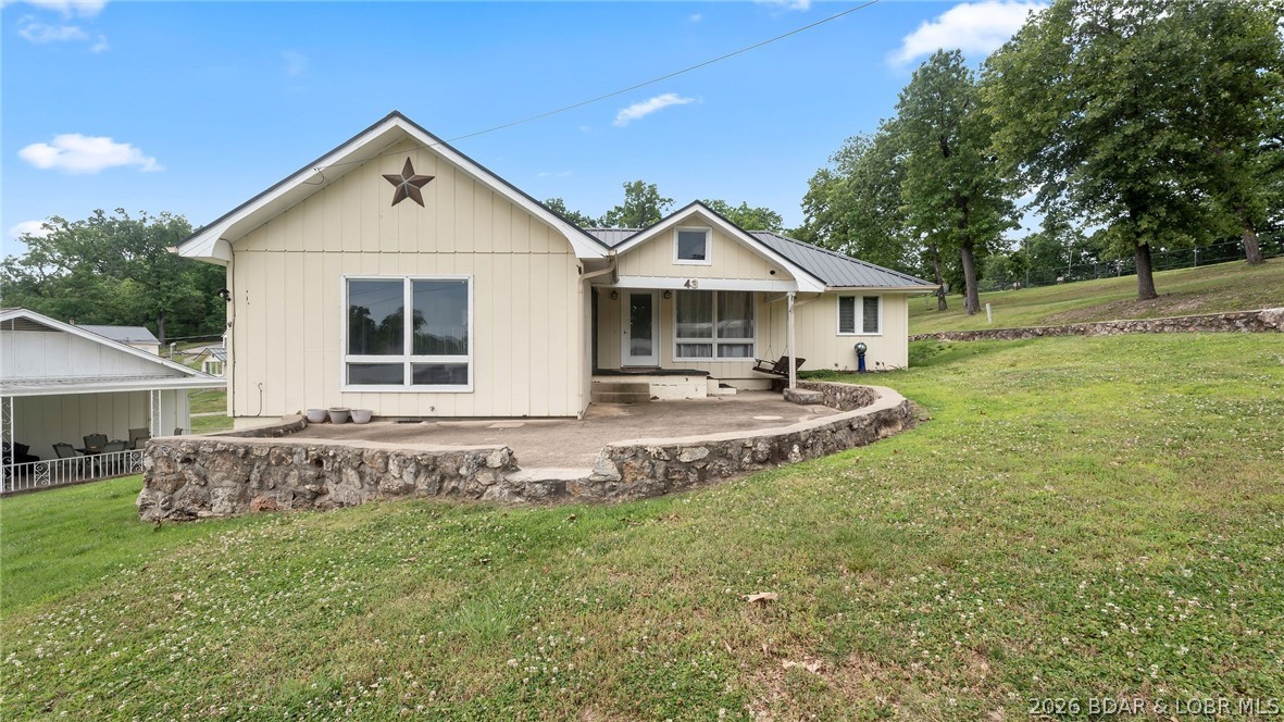 Charming 3-bedroom, 1-bath cabin offering all main-level living and the perfect lake lifestyle! This move-in-ready home features a cozy electric fireplace , creating a warm and inviting space to relax after a day on the water. The community is also developing a golf cart parking area and path, making it even easier to enjoy the neighborhood and waterfront amenities. Included with the property is your own 10x24 boat slip, making lake access easy and convenient. Located at the popular 8 MM in Buck Creek Cove near Shady Gators and Camden on the Lake, you’ll be just minutes from waterfront dining, entertainment, and all the excitement Lake of the Ozarks has to offer. From the road, you are right across from Bear Bottom Resort.  This is a perfect investment opportunity whether you're looking add an additional nightly rental to your portfolio, or for incredible 2nd home living opportunities. Call now to schedule your private showing!