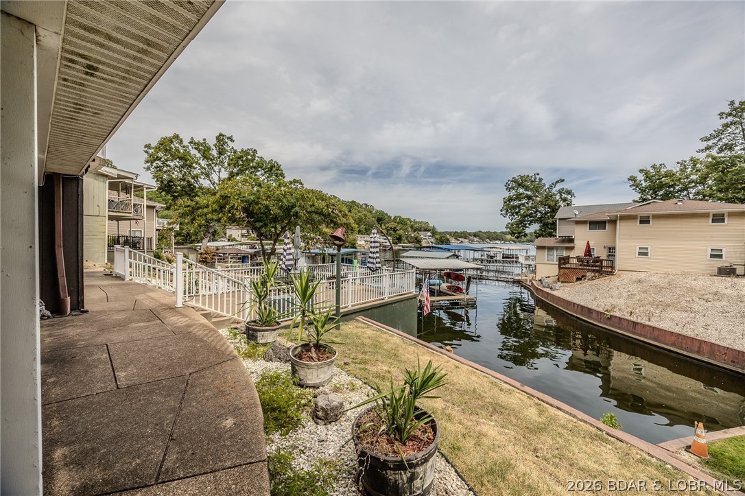 BIG PRICE REDUCTION –  now creating exceptional value for buyers $549,000! Seller is motivated and will consider any reasonable offer. This lakefront home checks all the boxes with panoramic views, a gentle 1-acre lot, blacktop all the way to the driveway, an attached 2-car garage, plenty of parking, and very few stairs to your private dock. Inside you'll find a beautifully remodeled kitchen, open-concept living and dining area with balcony access, 4 bedrooms, 2 full baths, and a spacious lower-level family/game room with walkout to a large concrete patio. Enjoy multiple outdoor entertaining areas including expansive decks, patio space, and a boathouse ready to become your dream guest house, lakeside bar, or hangout. Located in a peaceful protected cove close to shopping and popular lake attractions by both land and water. Sold fully furnished, including 2 kayaks and a lily pad. Pack your bags and start making lake memories Absolutely amazing Panoramic view of the lake