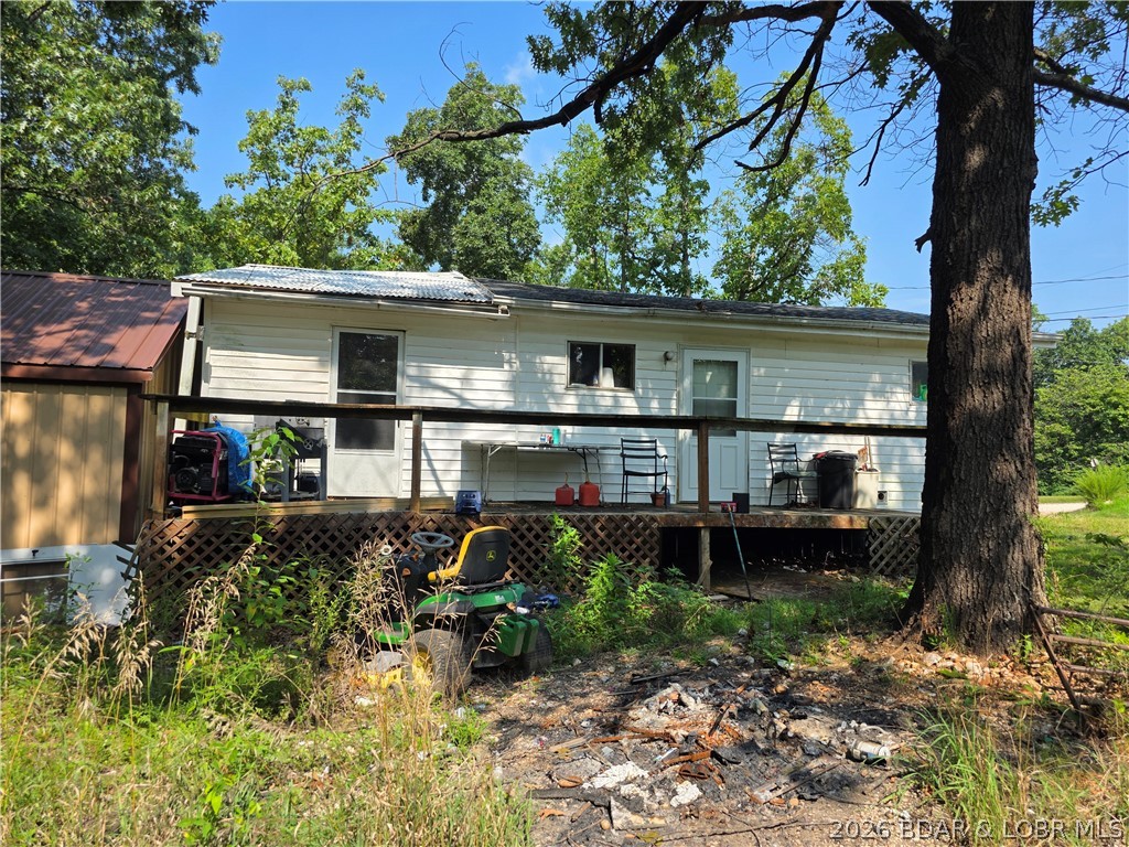 Cozy Lake-Area Home with Enclosed Porch & Bonus Shed
Nestled among mature trees near the Lake of the Ozarks, this charming single-story home offers peaceful living and flexible space. The main home features wood-look flooring, neutral tones, and plenty of natural light throughout. The living room provides a comfortable layout with a ceiling fan and room to relax. The kitchen includes a gas range, refrigerator, and ample cabinet storage.

Two bedrooms and one bath complete the main home — with the bathroom offering a walk-in shower and vanity. One bedroom also serves as a laundry area with washer/dryer hookups and wall-mounted air conditioning.

An enclosed front porch adds additional usable space, perfect for storage, hobbies, or a cozy sitting area. Outside, enjoy a shaded yard, small deck, and mature trees. All furniture and personal items will be removed prior to closing.

The property also includes a bonus shed — ideal for storage or projects. Please note: the shed does not have power.

This property offers comfort, simplicity, and potential — perfect for a full-time residence, weekend getaway, or investment opportunity in the Lake of the Ozarks area.