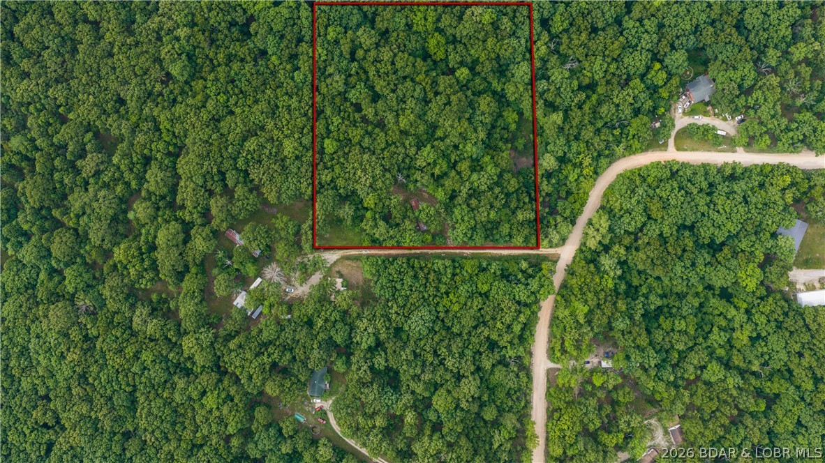 Discover the perfect blend of privacy and convenience with this beautiful 3.6-acre wooded property located between Osage Beach and Camdenton, just 2.6 miles off Hwy 54 down A Rd. A homesite is already established, with shared well, septic, and electric already in place—making it ready for your vision. Whether you’re looking to build your dream home, add a garage or ultimate man cave, or create the perfect Lake of the Ozarks getaway, this property offers endless potential. Enjoy the peaceful country setting while still being just minutes from shopping, dining, entertainment, and all the Lake Life activities you love. The existing mobile home is in rough condition and may need to be removed, but for the right buyer with a handy touch, there could be opportunity there as well. Rare combination of seclusion, utilities in place, and prime location—don’t miss this one! Adjacent 3 acre lot that includes a manufactured home is also available to purchase for a total of 6.62 acres. See MLS 3587526 for more details.