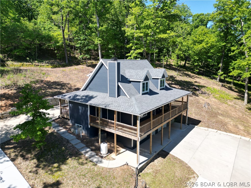 MOTIVATED SELLER!! This brand-new custom home sits on 3.05 wooded acres with stunning 55MM views and abundant wildlife, plus COMO Fiber Internet and a 12x32 covered boat slip in the community dock. In the upstairs of this spacious home you'll find a multi-use loft/bedroom area, a bathroom with tiled walk in shower, another bedroom, and 2 large walk-in closets. The main level's open-concept design is highlighted by a chef’s kitchen with custom cabinetry, quartz countertops, and stainless appliances which opens to the inviting vaulted living room featuring a high-end propane fireplace. The primary ensuite includes a double bowl vanity, beautiful tiled shower, access to the walk-in closet, plus the laundry room/half bath is just steps away!  All 3 open to the nearly 360° covered wrap-around deck--perfect for seasonal lake views including an active eagle’s nest. The walk-out lower level includes a family room with electric fireplace, a wheelchair-accessible bedroom and bath, and access to the extra-deep 27x12 garage. Buyer may opt for the home plus 3 more buildable lots of 2.21, 7.08, and 4.94 acres, each with water, sewer, and electric totaling 17.35 acres for $899,900. See survey map
