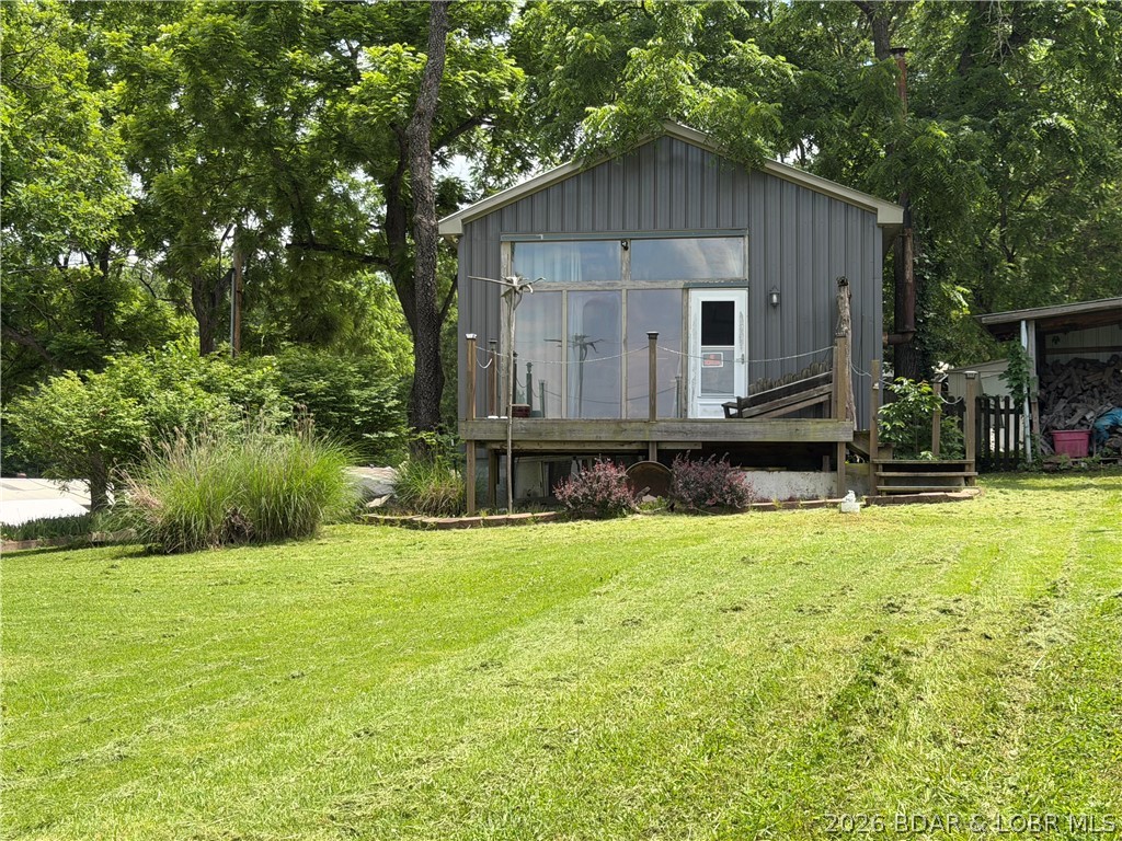 Endless  Potential & Year-Round Lake Views Under $200K!
On 84 Mile Mark in Warsaw, MO! Nestled on a spacious double corner lot, this Tier 2 property offers beautiful, year-round lake views and complete lake living without the hefty price tag. Right across the road is the public access and community dock.
The home is a blank canvas ready for your personal touch. Materials are already on-site and included to finish the gorgeous tongue-and-groove walls and floors, leaving room to build quick equity. Outside, the expansive double lot is perfect for a garden or custom landscaping.  
A big Shop for a RV with a work area and storage.