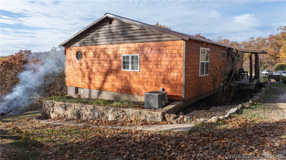 Freedom, Space, and Lake Access—Your 2.2-Acre Private Retreat awaits in the Ozarks!  Large home with detached 2 car garage off of "O" road in Laurie has NO HOA to tell you what you can and cannot do with your property.  Close to the boat ramp to launch your boat into a protected cove.  That is not a misprint, county taxes are under $500 ANNUALLY!  You get a country setting with the convenience of town just 5 miles away.  Five Bedrooms although 2 basement rooms are non conforming (one lacks a window, one lacks a closet) and a large kitchen area open to the dining room and living room.  The main bedroom closet is huge!  The garage is large enough to also house a workshop if room for 2 cars.  Some furnishings can stay with the new owner or we can move them out.   The sellers are leaving their riding mower so you can make quick work of the 2.2 acres and make it look amazing.  Investors, this would make a great rental (No HOAs) in an area that desperately needs more affordable housing.