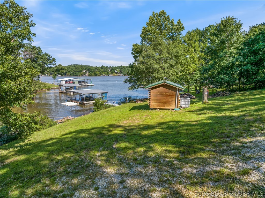 Discover the possibilities with this exceptional Lake of the Ozarks waterfront property featuring an impressive 225 feet of lake frontage and breathtaking panoramic views. Located in a quiet, peaceful neighborhood, this unique lot offers the freedom to create the lake getaway you’ve always wanted with no neighborhood restrictions.
Whether you’re looking to bring your RV, build a custom home, add a tiny house, or create the ultimate weekend retreat, the opportunities are endless. A log cabin currently sits on the property and is not included in the sale; it simply demonstrates how the seller has enjoyed and utilized the property over the years.
Enjoy easy lake access with a concrete dock already in place, perfect for boating, fishing, swimming, and soaking up the waterfront lifestyle. The neighborhood boat ramp provides additional convenience for launching your watercraft.
If you’ve been searching for a versatile lakefront property with incredible views, ample shoreline, and the flexibility to make it your own, this is a rare opportunity you won’t want to miss.