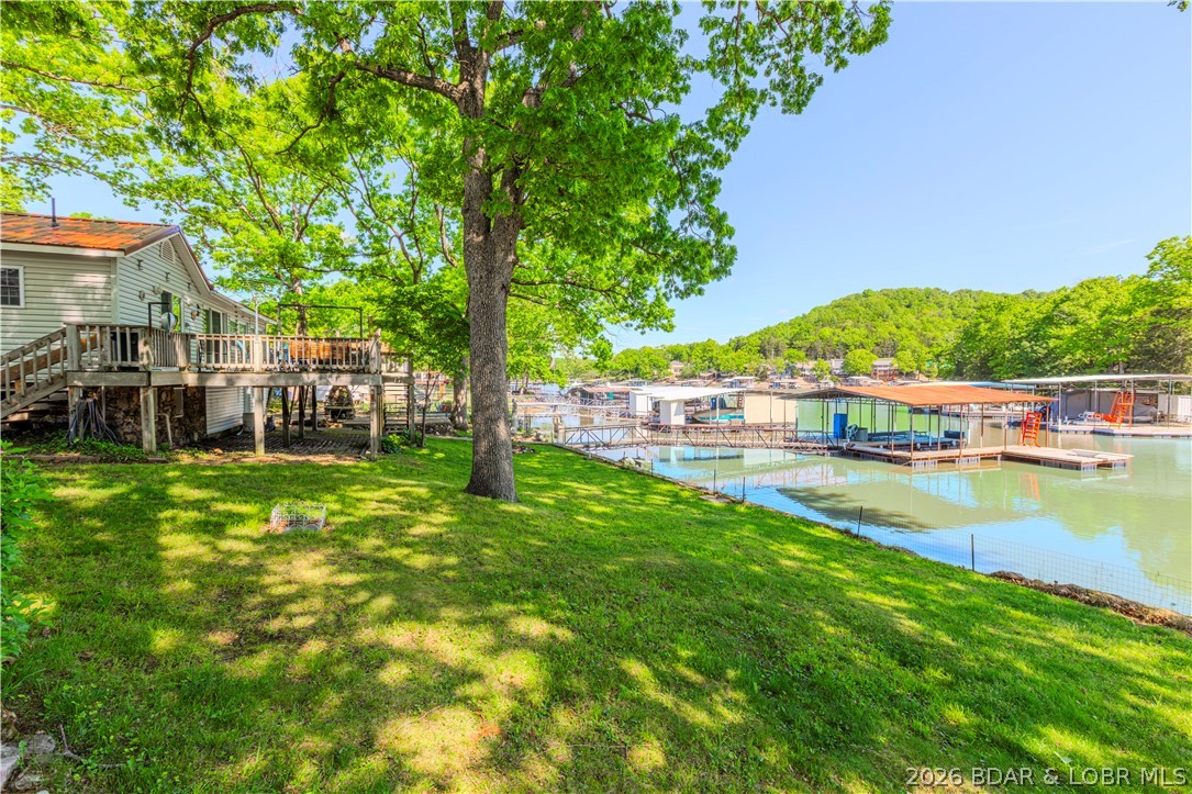 Peaceful lakefront living awaits. Tucked inside a protected deep-water cove with 128 feet of private shoreline, this property offers the perfect blend of privacy, serenity, and effortless lake life.

The main home features 1 bedroom and 1 bathroom, while a separate guest house includes 2 bedrooms and 1 bathroom—ideal for hosting guests or creating a flexible retreat space. It’s a rare opportunity to enjoy quiet waterfront living with room for everyone.

Even better, you’re just a boat ride away from some of the Lake’s favorite waterfront spots, including Captain Ron’s Bar & Grill, Bull Dogs Beach House, Larry’s On the Lake, and Fish & Company—making it easy to enjoy dining and entertainment right from your dock.