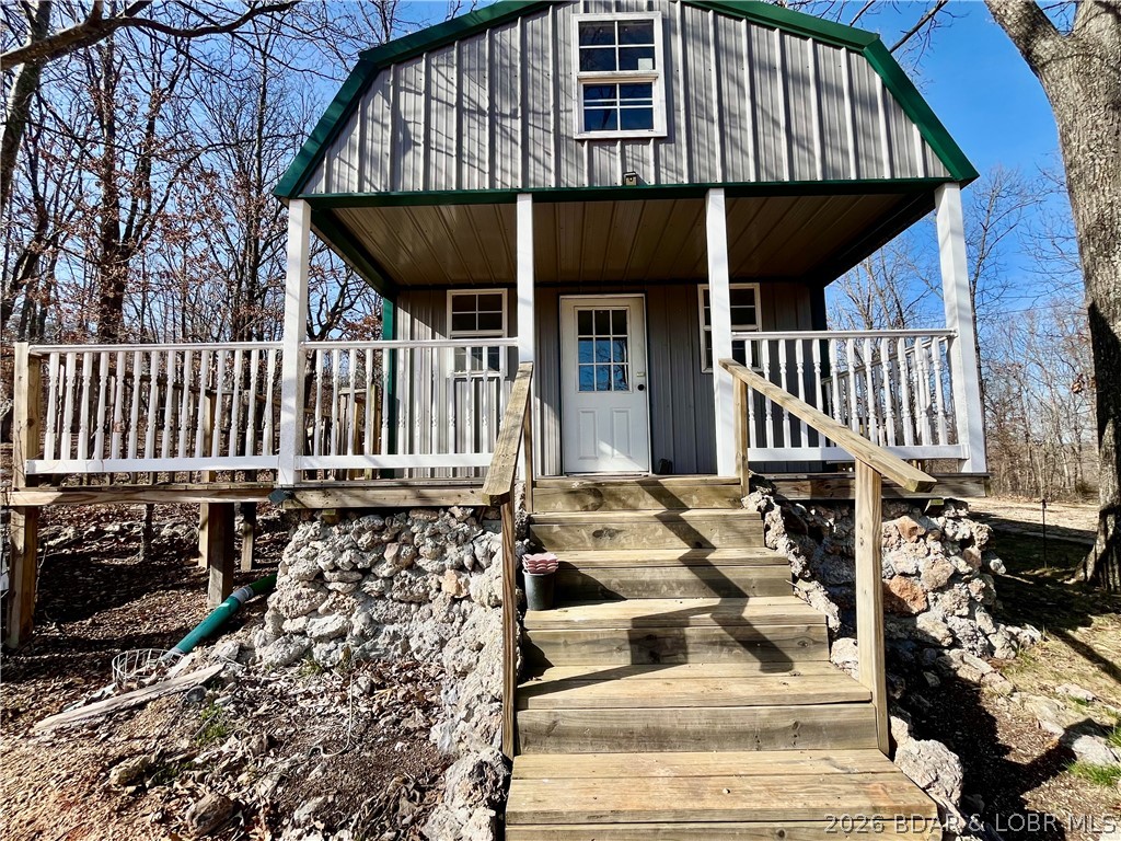 This cozy tiny home offers a simple, low-maintenance lifestyle with just enough space to make it your own and sets on almost 5 acres.  Inside, you’ll find a functional layout with 1 bedroom, a loft, kitchen, living area, and washer/dryer hookups—perfect for full-time living, a weekend escape, or even a rental opportunity. The covered front porch and back deck add extra living space, ideal for relaxing and enjoying the quiet surroundings. With no restrictions, you have the freedom to use the property how it fits your needs—whether that’s a getaway spot, investment property, or a place to simplify and slow down. A few updates like fresh paint and flooring could quickly elevate the space and add value.Located close to a public boat ramp, it’s a great option for anyone who loves easy access to the water without the price tag of lakefront property.
