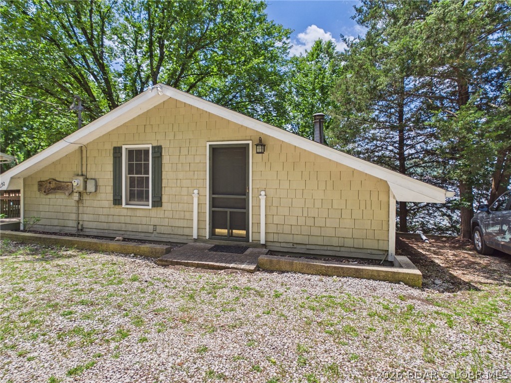 Enjoy easy lakefront living in this well-maintained 2-bedroom, 2-bath home at the Lake of the Ozarks. Offered as a turnkey waterfront retreat, this property is ideal for a full-time residence, weekend getaway, or low-maintenance lake home away from the city. Step outside to a shaded lakeside patio designed for relaxing and entertaining. Enjoy beautiful lake views, crisp fall mornings, and convenient access to the water. The private dock includes an 8,000-pound boat lift with remote, making it easy to get your boat in and out of the water. A dock de-icer is also included to help protect the dock and equipment during the winter months. A storage shed provides space for fishing gear, lake toys, floats, and other outdoor equipment. With minimal yard maintenance and an easy-care design, you can spend less time working and more time enjoying boating, fishing, and life at the lake. This inviting Lake of the Ozarks waterfront home is ready for its next owner to begin making memories on the water. Schedule your private showing today.