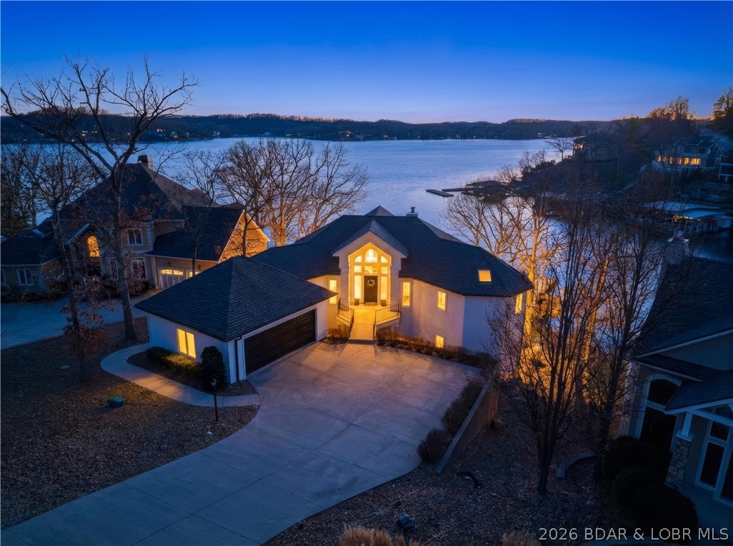 Experience unparalleled lakeside luxury in this fully remodeled masterpiece designed by Harris Interiors. Perfectly positioned on a rare flat lot just 10 steps to the water, this exquisite home offers effortless access to a cove-protected cruiser dock and breathtaking main-channel views from every bedroom. Featuring 5 bedrooms, including 3 private en-suites, and 5.5 beautifully updated bathrooms, this residence blends modern sophistication with relaxed lake living. Walls of windows showcase panoramic water views, while the open layout elevates both comfort and style. Outside, the expansive lot provides exceptional parking—an uncommon luxury on the lake. Located in the prestigious Village of Four Seasons, residents enjoy premium amenities including indoor and outdoor pools, a fitness center, and pickleball courts. This is lakeside living at its finest—move-in ready, impeccably designed, and truly one-of-a-kind.