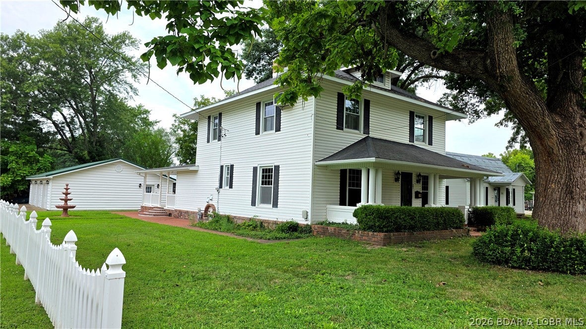 SELLER SAYS BRING YOUR OFFERS! Turn-of-the-century home beautifully updated while preserving its timeless charm! This inviting property features a spacious primary suite complete with private bath, washer/dryer, walk-in closet, & extra storage. The oversized primary bedroom showcases a stunning wall of windows & private deck & entrance overlooking the water fountain. You will love the woodwork in the open living room with big windows for natural light & the formal dining room to gather w/family. Bonus room upstairs could be 5th bedroom, craft room, or gym, the possibilities are endless. Enjoy peace of mind with new appliances, many new windows, updated flooring, some new plumbing, electric fireplace & additional improvements throughout. Stairs to attic for additional storage and a partial basement. Sip your morning coffee or unwind in the evening on the charming covered front porch and enjoy the neighborhood atmosphere. Outside, you'll find a 3-car garage/workshop, storage shed, and a location that is hard to beat, all within walking distance to shopping, restaurants, banking and additional businesses. Character, comfort, and convenience wrapped into one delightful property!