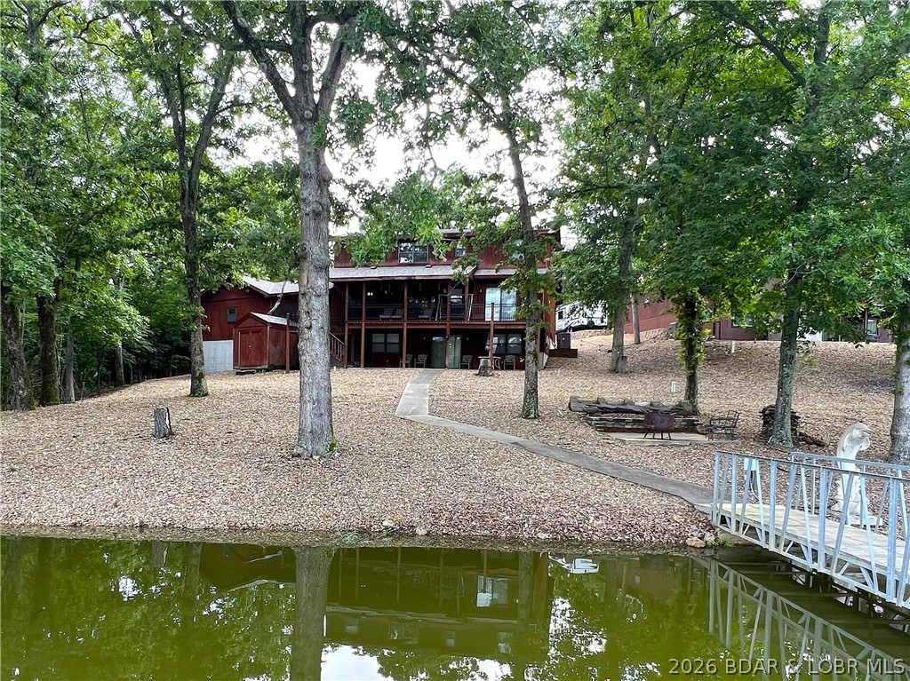 Lakefront living at its finest on the 84 MM! Welcome to 23069 Peppermint Dr, a property that checks every box in your search for the perfect Lake of the Ozarks retreat. Nestled in a fantastic deep-water cove with a gentle sidewalk leading to the concrete dock, this spacious 3-bedroom, 3 full bath home offers an open floor plan, oversized rooms, abundant natural light, and beautiful lake views. The sun porch and expansive lakeside decks are perfect for relaxing or entertaining.

The finished lower level provides plenty of space for additional beds or future bedroom expansion. Most furnishings are included, so you can start enjoying the lake immediately. A 2-car garage and storage shed provide ample room for your vehicles and lake toys.

Whether you're searching for a full-time residence or a weekend getaway, this home delivers. Just bring your swimsuits and your boat—your Lake of the Ozarks memories begin here!