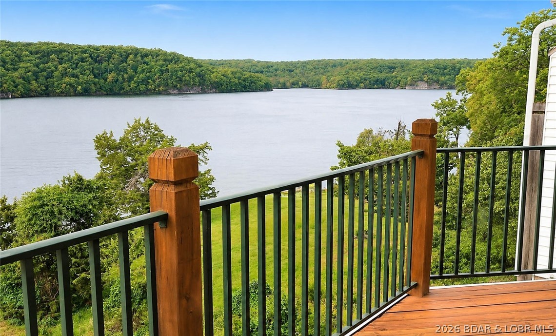 Looking for peaceful relaxation at Lake of the Ozarks, here it is! Overlooking the tranquil state park on the Grand Glaize Arm, an area known for quieter waters, exceptional fishing, boating, and endless water activities. This 3-bedroom, 3 full-bath condo offers convenience and comfort, with a 12x30 boat slip included. Inside, you’ll find a two-level condo with a spacious loft and second suite. The open-concept layout is beautifully decorated, offering breathtaking views, afternoon shade, and a clear view of your dock. Enjoy peace of mind with a newer HVAC system, a water heater that is only a year old, and appliances that are just two years old. Both front and lakeside decks have been replaced. The included boat lift, only four years old, enhances your boating experience. Community amenities feature a pool, clubhouse with workout area, on-site manager, and a pet-friendly atmosphere. Perfect for full time living, a great weekend getaway or investment property, as short term rentals are allowed. Nestled in the heart of Lake of the Ozarks State Park, you’ll appreciate abundant wildlife and the perfect blend of nature and lake living.