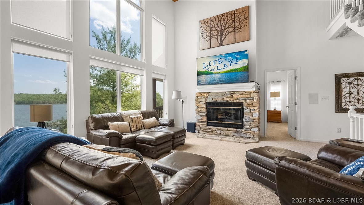 Incredible lake home from the inside & the out, located in a nice taken care of neighborhood. This 4bed/3.5bath home has a multitude of features you will enjoy. Massive wall of windows in the main living area on the lakeside-providing stunning natural light, cathedral ceilings & offering breathtaking views of the Gravois 2MM. Living room features large stone gas fireplace, new carpet, open concept to dining room/kitchen & access to open deck/grilling area. Kitchen contains custom cabinets, granite counters & a large pantry with additional beverage fridge inside. Each bedroom offering a lakeview with 2 bedrooms being en-suites w/ walk-in closets & large bathrooms. Lowest level features a nice family room, 2 bedrooms & deck access with tons of room offered for entertaining. A few more steps off the deck to your concrete dock with large swim platform, storage shed & 2 slips; a 12x36' and a 8x20' (under roof) slip. This updated home also comes TURN-KEY so you don't have to worry about moving furniture in! You'll find that this property provides an inviting atmosphere with it's pristine condition, updated finishes & a functional layout that's perfect for everyday use or 2nd home living.