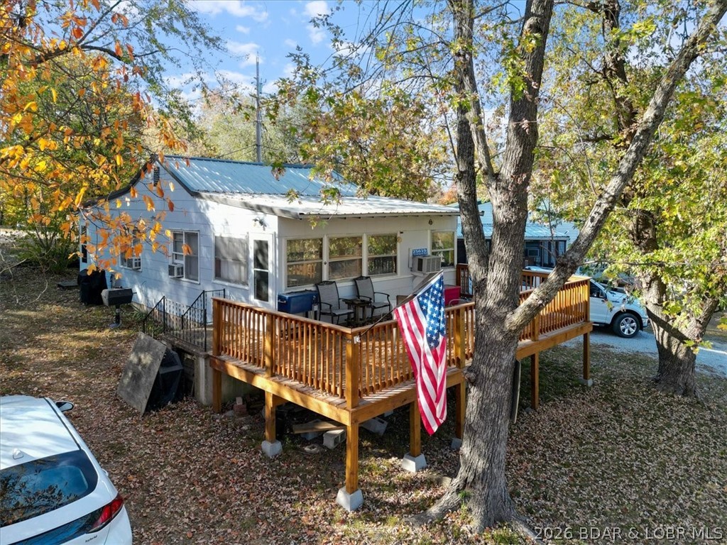 Escape to this 2 bed, 1 bath lakeside retreat located on 3 spacious lots! This charming home boasts a great view of the lake which can easily be enjoyed from the expansive deck, ideal for morning coffee, evening sunsets, or entertaining guests.  The property also features a 24x30 metal building with concrete floor, perfect for additional storage, a workshop, or a hobby space.  A short stroll away, you will find a swim beach for relaxing summer days and a community boat ramp, providing easy access to the lake for boating and water sports.  Conveniently located within walking distance is a popular restaurant and bar, this property allows you to enjoy lakeside living with the added luxury of nearby dining and entertainment.  Whether you are looking for a weekend escape or a peaceful full-time residence, this lakeside gem offers everything you need for a perfect retreat.