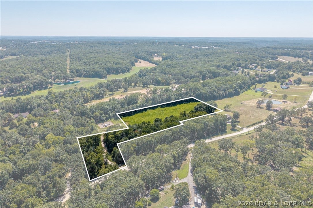 Rare find! Prime 5.56-acre level lot on Milli fork Lane, located just off Hwy 135! Set in a quiet neighborhood surrounded by nice, attractive homes, this open parcel offers minimal prep work-just minor brush clearing needed to lay out your dream home. Features easy gravel road access, grid power and a public water connection nearby. Enjoy level terrain, privacy, and room to spread out while staying minutes from shopping, dining, and boat launches. Open utility-ready acreage in this area is hard to find-come take a look.