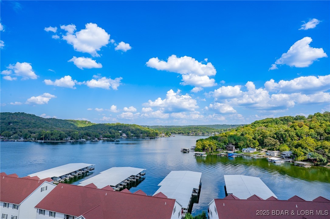 Top-Floor Lake View Condo. 3 bedroom 2 bathroom in Camdenton, minutes to Old Kinderhook golf course, shopping and great schools. Features vaulted ceilings, open concept, electric fireplace and a large balcony with expansive panoramic lake views and 2 pools on the Big Niangua MM#8
Includes a 12x32 boat slip and a 12,000 lb Poly lift.
Whether you're enjoying morning coffee with a view, hosting friends, this home offers the ideal balance of comfort, convenience and lifestyle. This home is ready for your personal touch to make it your own!