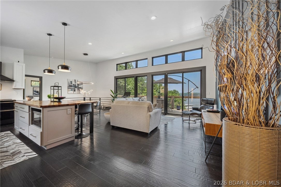 The views from this modernly constructed lakefront home are outstanding! As you walk in you are drawn to the expansive main channel views through the wall of triple 8 ft, black sliders. This 5 bedroom home was constructed with quality products including vertical fiber cement board siding(hail, water and fireproof), 40 year metal roof, and a slew of high end interior finishes. The home is situated wonderfully on a large lot in Four Seasons that offers 168' of shoreline & gives you a very private setting. The sellers are leaving nearly everything so here is your chance for a turn key residence. One of the best parts is you can enjoy the view of the main channel but your dock is situated towards the back of the cove where it will not get tore up from the rough water, you can enjoy swimming on the roughest of weekends! Interior features include soaring ceilings, quartz counters, an oversized island with prep sink, & master suite with a spa-like bath. The home is south facing so you will certainly enjoy both huge decks, one of which has an included hot tub. Be sure to check out the lower level golf cart garage and the 526 sq ft unfinished area above the garage which is ducted for HVAC.