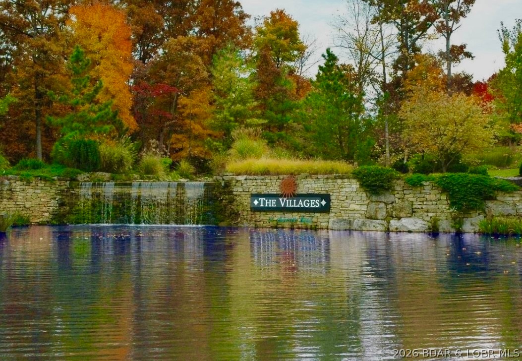 Build your dream home in the highly sought-after...The Villages at Shawnee Bend! This exceptional 2nd tier lot offers beautiful lake views without the lakefront price tag. Perfectly positioned in a well-established, upscale neighborhood, you’ll love the peaceful setting, paved roads, and convenient location by both land and water. Enjoy the best of lake living with close waterfront dining, golf, and entertainment. Whether you're ready to build now or planning for the future, this lot is an incredible opportunity to create your custom lake retreat in one of the area's most desirable developments. Lake Access available via community boat ramp PLUS a new marina is being built.... perfect place to lease a slip!  Water and Sewer District is available for Hook Up! Adjoining lot available for extra!