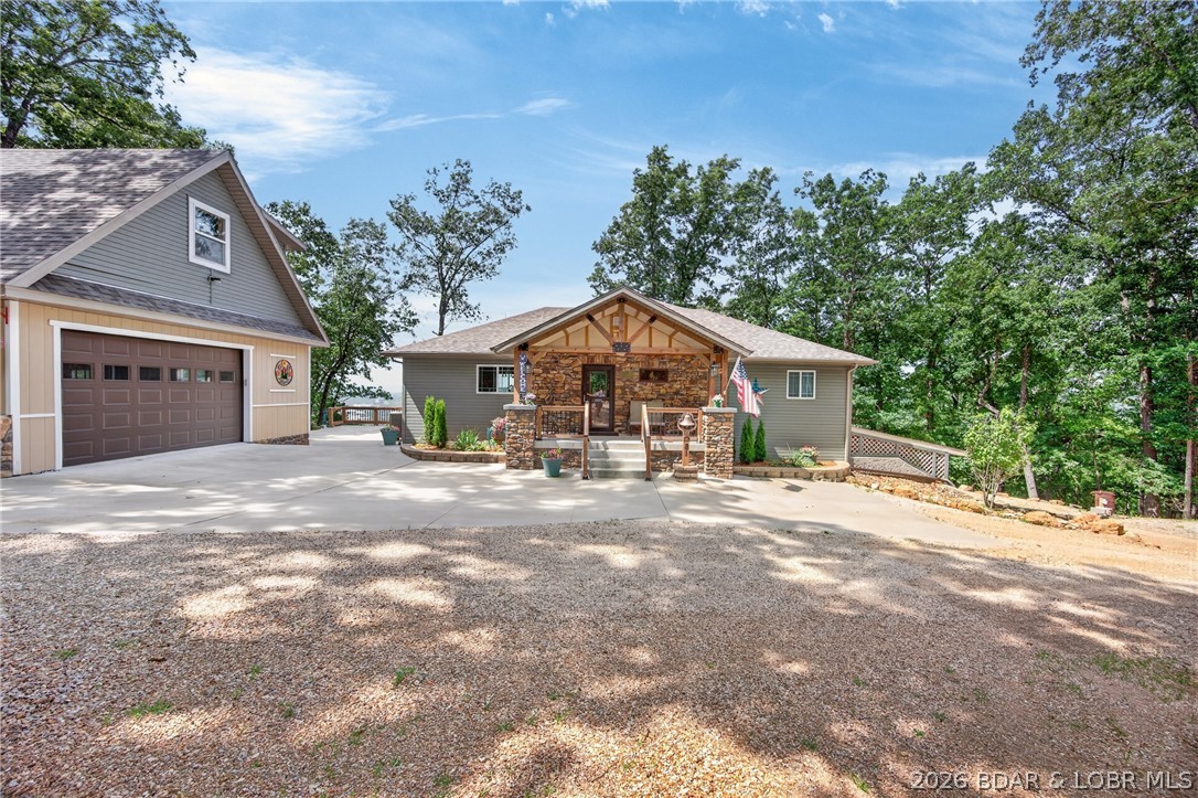 Experience the perfect blend of quality craftsmanship, flexibility, and breathtaking scenery in this custom-built home on 3.5 private acres overlooking Lake of the Ozarks. Constructed with rare Insulated Concrete Form (ICF) walls, this residence offers exceptional durability, energy efficiency, sound reduction, and low utility costs. Panoramic lake views stretch from the Hwy 54 bridge to Old Kinderhook, creating an ever-changing backdrop from nearly every room. Designed to live like two homes in one, the walkout lower level features its own kitchen, living area, bedrooms, bath, and laundry—ideal for multi-generational living, extended family, or long-term guests. The main level showcases engineered wood plank flooring, 36” doorways, a custom alder kitchen with granite countertops, premium appliances, pantry, German silver sink, and a spacious lakeside primary suite with private laundry. Heated/cooled 36x24 garage with finished studio apartment above, plus RV hookup, generator hookup capability, covered decks, expansive patios, and no HOA.