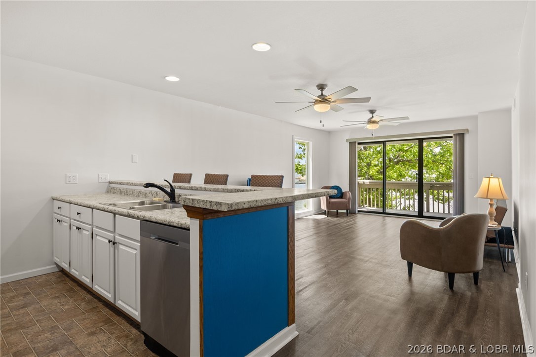 Enjoy the lake lifestyle at Pelican Bay Condominiums. This turn-key, waterfront condo at the 26 mile marker comes fully furnished, making it a seamless transition for your next residence or long-term rental investment. The open-concept living area features updated flooring and neutral tones, flowing into a modern kitchen equipped with stainless steel appliances, crisp white cabinetry, and a vibrant breakfast bar. Large sliders and floor-to-ceiling windows in the primary suite frame breathtaking main channel views and provide direct access to the private covered deck. This unit offers 3 bedrooms and 2 bathrooms, including a spacious master suite. For the boating enthusiast, the list price includes a 10x24 boat slip, ensuring your lake adventures are just steps away. Residents enjoy wonderful amenities that include a large community pool, club house, lakeside boardwalk, grilling areas, and boat trailer parking. Experience the beauty of Lake of the Ozarks from this move-in-ready gem.