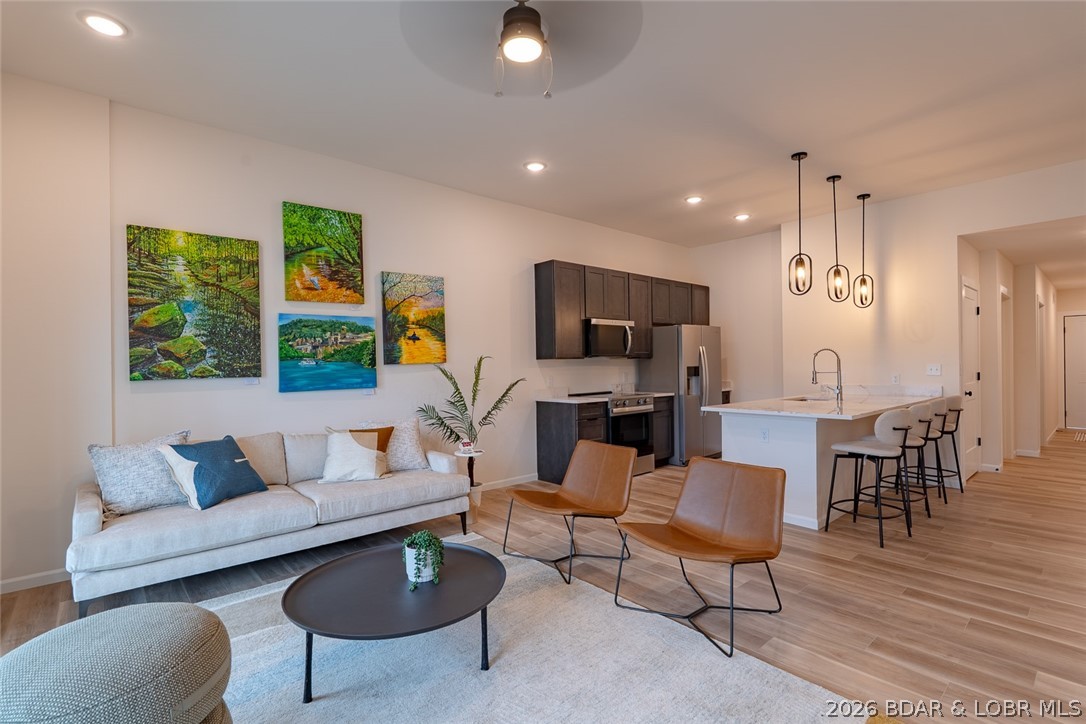 Walk right in—no stairs, no hassle—and enjoy the best of lake living. This second-floor (walk-in level) Ember Ridge condo offers the perfect blend of convenience and elevated living. Featuring a spacious, open-concept layout with 3 full bathrooms, a large pantry, and additional storage—ideal for both everyday living and hosting guests. Built with durable steel framing and designed with a clean, modern style, this brand-new construction stands apart from anything else at the Lake of the Ozarks. Property has an elevator. Ideally located just minutes from several of the lake’s most popular waterfront restaurants and attractions. Dock slips and PWC slips available. Whether you’re looking for a personal getaway or a vacation rental investment, this unit offers flexibility to fit your needs. Photos are of Model Unit #205 and are used to showcase design and finishes—layout and selections may vary.