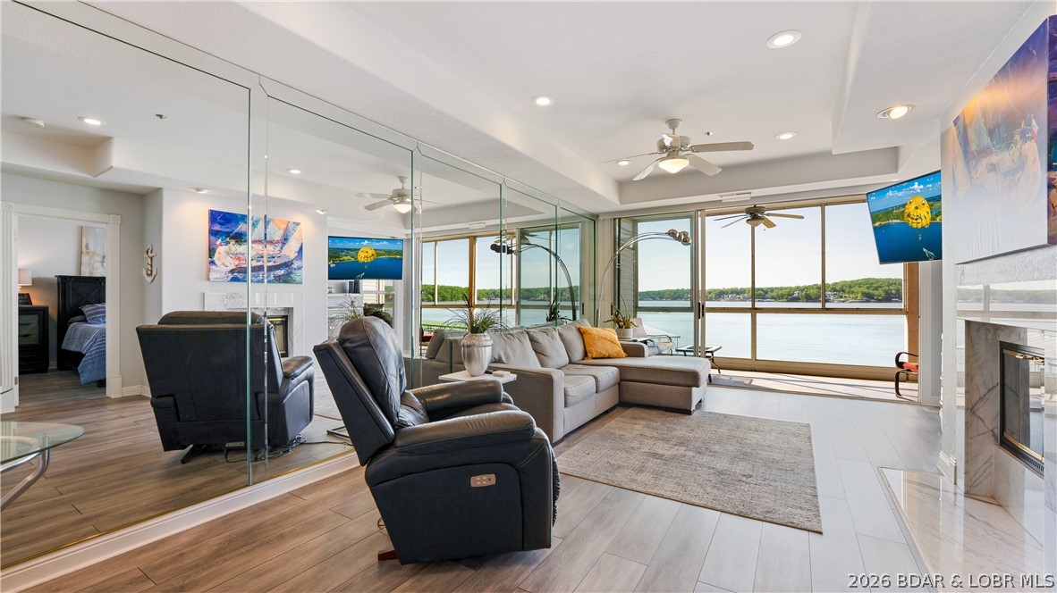 NEW HVAC JUST INSTALLED JULY 16th - SAME PRICE! Enjoy stunning, unobstructed waterfront views of the main channel from this walk-in 2 bedroom, 2 bathroom condo, featuring just four steps off the parking lot.  Ideally located on the 14MM central to all the lake’s hotspots and at the beginning of Horseshoe Bend for easy in and out on those busy weekends.  The screened in deck will be your favorite spot as you watch the boat action and hear the relaxing splash of water and see turtles sunning. The 12’ x 32’ boat slip with approximately 12,000 lb. hoist is visible from the condo and with no steps to get to the wave-break protected dock, it’s a breeze rolling your cooler to the boat!  Move-in ready and the kitchen is fully updated with brand new ceiling-height cabinets, solid surface counters, and stainless steel appliances.  Furnished and conveniently located next to one of two pools and the clubhouse with fitness equipment.  Tennis/pickleball/sports court available for a little friendly competition. Perfect for lakefront living with easy access to amenities, recreational activities, golf courses, shopping and some of the lake’s best restaurants and music venues.