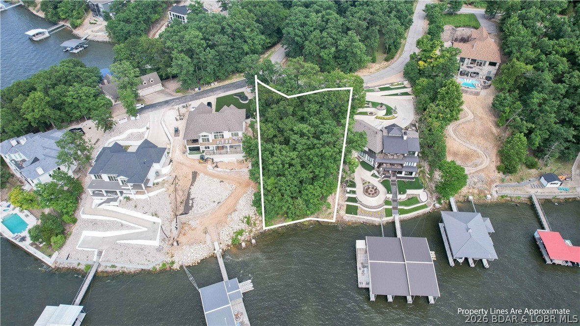 Imagine designing the lakefront home you've always envisioned—walls of glass capturing panoramic main channel views, a pool overlooking the water, and a custom dock extending from your own 99 feet of shoreline. Located in prestigious Porto Cima at the 14MM, this exceptional lakefront homesite offers deep water, allowing for the dock configuration of your choice, and is surrounded by beautiful newer homes in one of the Lake's most desirable luxury communities. Enjoy front-row views of fireworks and a setting that perfectly balances privacy, scenery, and convenience. Just around the corner, you'll find the Jack Nicklaus Signature Golf Course, The Club at Porto Cima, & Porto Cima Yacht Club with a variety of membership opportunities available. Ownership also includes access to Four Seasons amenities including multiple pools, tennis courts, hiking/biking trails, RV park/camping area, three private fishing lakes, Kay's Point Pavilion, dock & boat launch, playground, skate park, basketball courts, and the new aquatic center. This is more than a homesite—it's an opportunity to create a legacy property and enjoy the lifestyle that makes Porto Cima one of the Lake's premier destinations.