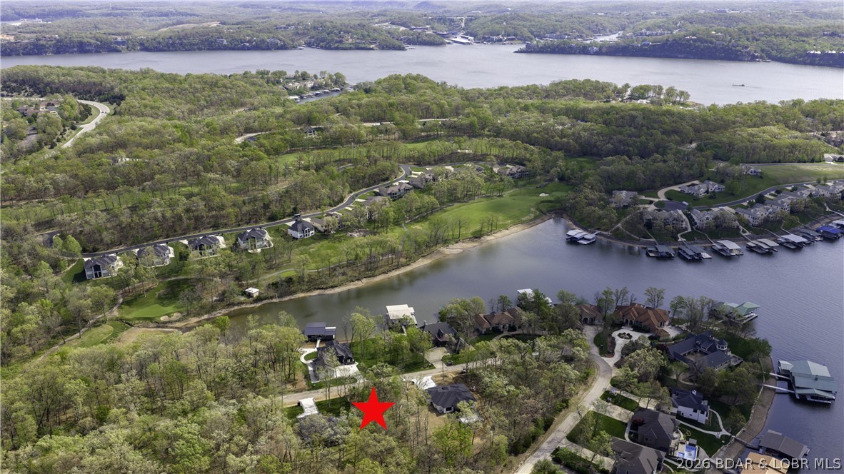 Flat lot in Porto Cima! Build your dream home at the Lake. Builder available! This lot offers seasonal lake views, great location across the street from Lake Front Homes. Harbor 19 Marina is close by also if you need a space for your boat. Bonus Eagles nest just a couple lots away. This lot includes Four Seasons amenities. There are Pickle Ball courts and swimming very close. There is also the Indoor Pool available just down Horseshoe Bend. Come and check it out!