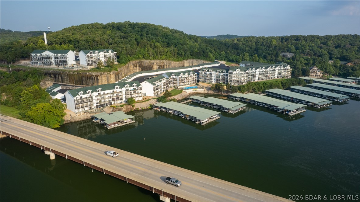 Rare DOUBLE condo offering 3,495 sq ft of lake living! This impressive property features 7 bedrooms, 6 full baths, two full kitchens, and two main-level laundry closets, making it ideal for a nightly rental investment, large family retreat, or multi-family lake getaway. Four bedrooms offer private en-suite baths, plus two additional hall baths for added convenience. Enjoy beautiful views of the “quiet side” of Lake of the Ozarks from the heart of the condo, creating the perfect setting for relaxing or entertaining. Currently operating as a nightly rental, with a furniture package available at additional cost. Advance scheduling required for showings. A rare Lake opportunity with space, flexibility, and income potential!