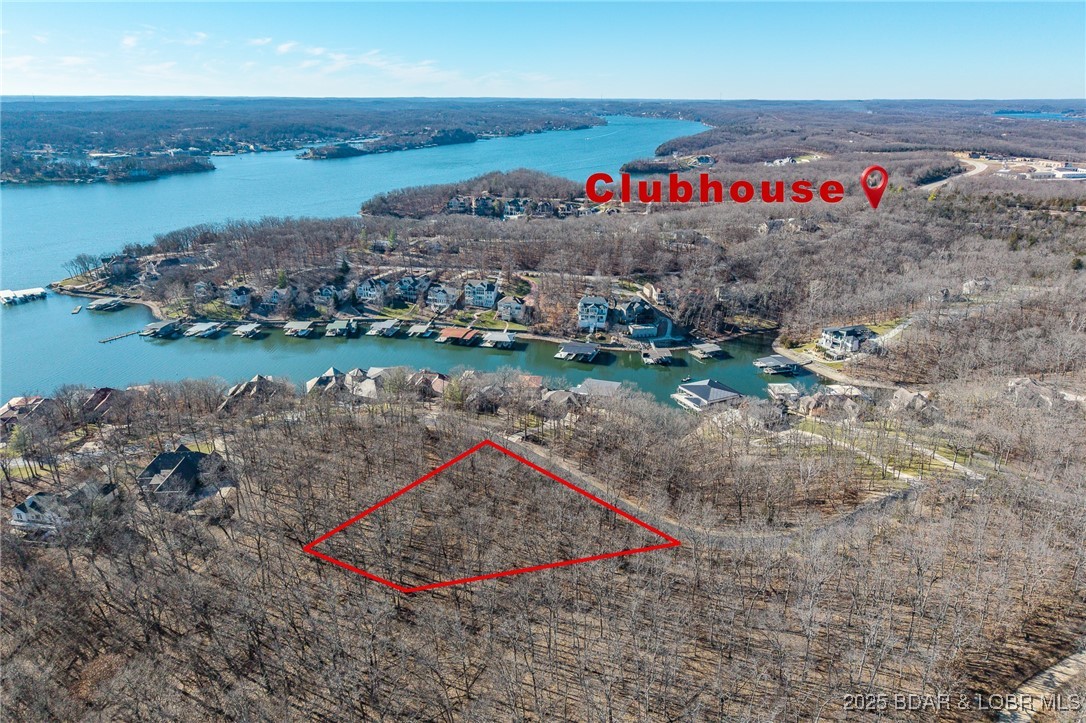 This Lakeview lot at The Villages at Shawnee Bend offers scenic views of the Lake of the Ozarks paired with the amenities of a premier master-planned community. Enter through the striking grand waterfall entrance and experience a neighborhood designed for both relaxation and recreation. Homeowners enjoy a welcoming clubhouse, multiple community pool, championship tennis courts, and pickleball facilities, as well as parks, and playgrounds. With paved roads and underground utilities in place, this lot is ready for a thoughtfully designed home that captures the lake views while embracing a vibrant, resort-style atmosphere.