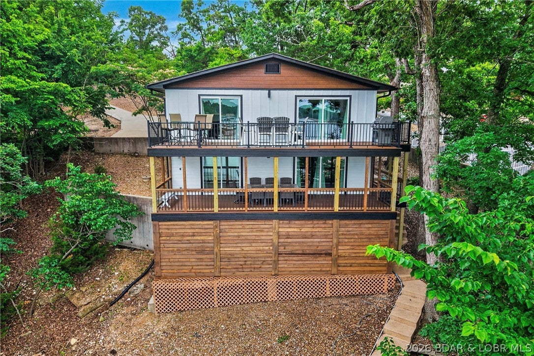 LAKEFRONT LUXURY • 1.6+ ACRES • 2,646 SQ FT • COMPLETELY TRANSFORMED! A rare opportunity in the heart of Osage Beach! This stunning 3BR/3BA lakefront home has been completely transformed from top to bottom, offering beautiful main-channel views, cove-protected water and a private dock with 12 x 34 boat slip & PWC slip. Nearly every detail has been upgraded, including a gorgeous new kitchen with appliances, countertops, refinished cabinetry and coffee bar; renovated baths; new flooring, doors, trim, windows, lighting, electrical and PEX plumbing. Exterior improvements include new LP SmartSide siding, gutters, flashing, railings and completely rebuilt Trex decks. Major improvements include a professionally pinned foundation with transferable warranty, water mitigation system, new insulation and partial reframing. The lower level provides additional entertaining space with wet bar, ice machine and storage for lake toys. City sewer! Just minutes from premier dining, entertainment, & shopping. Room to build on 1.6 acres. This is lake living at its finest. Extensively transformed, spacious, private and ready to enjoy. Home is offered unfurnished; furniture package available separately.