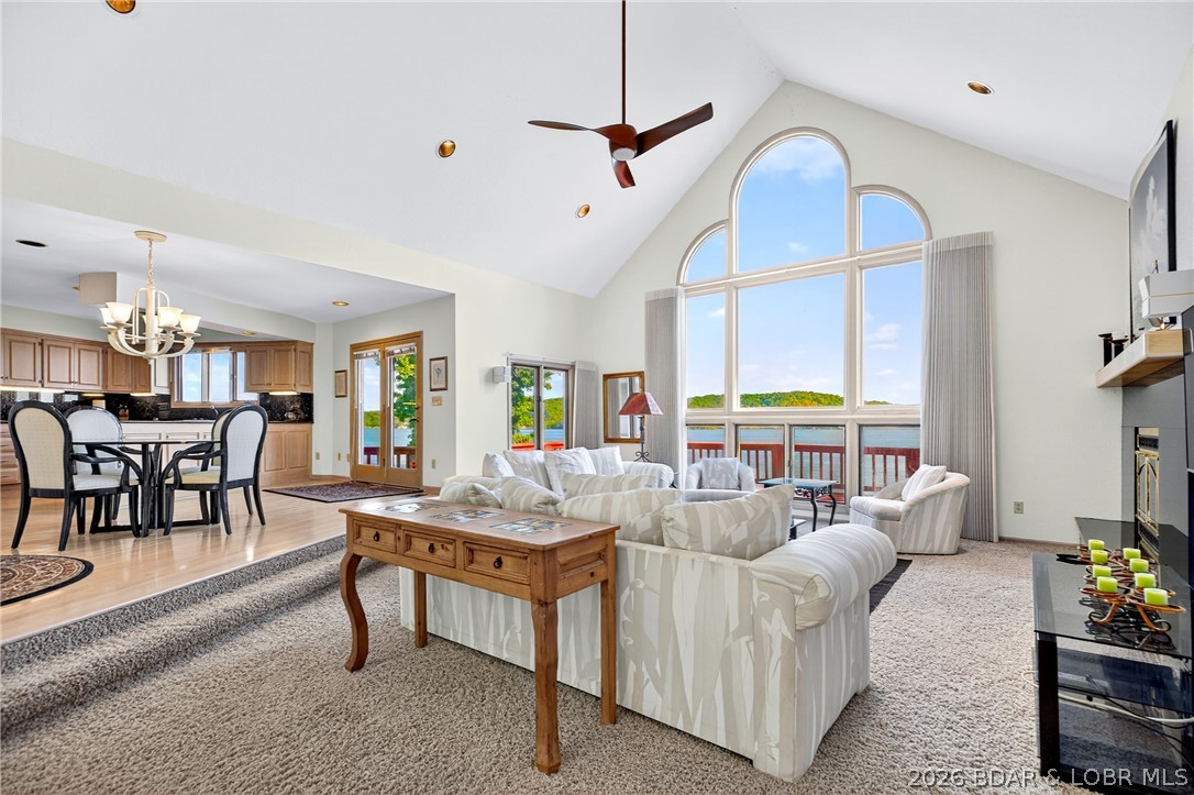 609 Point Charles Rd in Sunrise Beach offers luxury lakefront living with 3,700 sq ft, main-level living, and breathtaking views at the 31 MM. This 3-bedroom, 2.5-bath retreat features vaulted ceilings, an open floorplan, 2 gas fireplaces, custom cabinetry, wet bar, and a spacious lower-level great room with pool table included. Also has an office. Enjoy upper and lower decks overlooking 100 ft of shoreline, a fenced lakeside yard, seawall, and an impressive 3-well covered dock with 12x40 and 12x28 slips, 4 PWC spaces, hoists, and swim platform. Updates include a 2025 furnace and garage door system, 2023 water heater, and 3-year-old roof. Attached 2-car garage, plus the lot across the street is included, providing room to build another garage or shop.