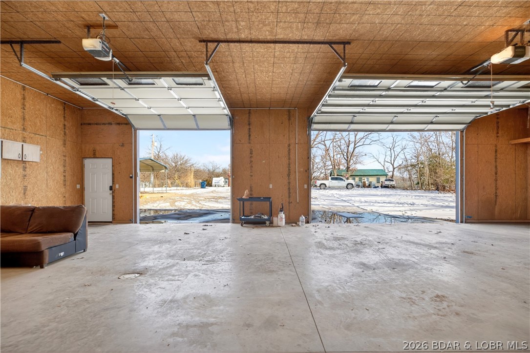 31962 Georgia Rd in Gravois Mills is a place to slow down and savor a little more space, set on 3.10 acres with a mix of open ground and woods for privacy and play. Built in 2020, this charming one-level home offers approx. 1,200 sq ft with 3 bedrooms and 2 baths, featuring easy-care laminate flooring, ceiling fans, a pantry, and a comfortable primary suite with a walk-in closet and walk-in shower. Step onto the covered deck for fresh-air mornings and laid-back evenings, then slip into the hot tub and let the day melt away. A greenhouse invites you to grow, tinker, and enjoy the outdoors at home.

The 40x60 detached shop/garage takes the lifestyle even further with 3 bays, an RV door, concrete flooring, and plenty of space for projects, storage, and toys. A studio apartment on the main level adds flexible bonus space for guests, hobbies, or a home office. City sewer hookup coming soon—another convenience to add value and future ease.