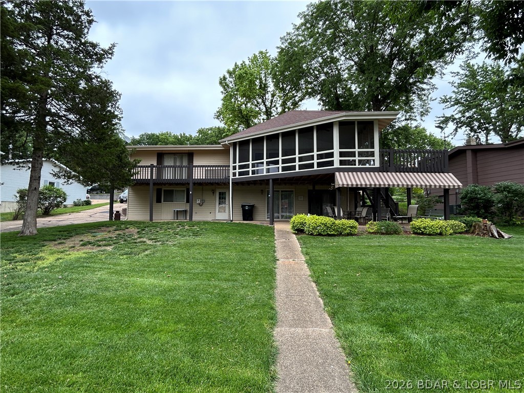 Everyone loves a FLAT LOT CLOSE TO TOWN for ease of enjoyment and great resale value!  Close to two top notch golf courses also.  Good water depth also under the two well concrete dock.  This has so many valuable features.  The private boat ramp is such an appeal, after you have one on the lakefront you will always want one!  HaHa Tonka state park is just a few turns away featuring hiking, a huge spring, world class fishing at times.  Central sewer means no septic laterals to inspect or maintain ever!  New roof just a few years ago, this is a well kept home.  Propane fireplace downstairs even heats the home when the power is off.  Beautiful kitchen with solid surface countertops and gorgeous cabinets.  Pass thru kitchen window opens to a huge screened porch that has a panoramic view of the lake.  There is a sundeck off of the master bedroom as well as sun deck or bbq deck off of the kitchen side.  The kitchen exterior door is so handy for bringing in groceries or taking coolers to the dock.  Large downstairs covered porch looks right out onto the lake.  One car garage with room to build on.  Convenient location to town, flat lot, and well kept home, come and invest here!