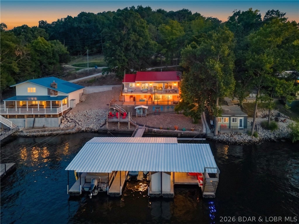 Lakefront living at its best! This 3-bedroom, 2-bath Lake of the Ozarks home offers incredible views, an impressive outdoor living setup, and plenty of space to enjoy everything lake life has to offer. Inside, you’ll find a bright, comfortable layout with an updated kitchen featuring abundant cabinetry and spacious countertops. The living room showcases a beautiful stone fireplace and large windows that bring the lake views inside. Step outdoors and the property truly shines with expansive decking, multiple seating areas, and breathtaking views of the water. The covered dock provides the perfect place to spend summer days on the lake, with plenty of room to relax, entertain, swim, or enjoy your favorite water toys. Nightly rentals are allowed, making this property an excellent opportunity for those looking for a lake getaway, investment property, or both. From the peaceful setting to the incredible waterfront and outdoor spaces, this property is ready to make lasting Lake of the Ozarks memories!