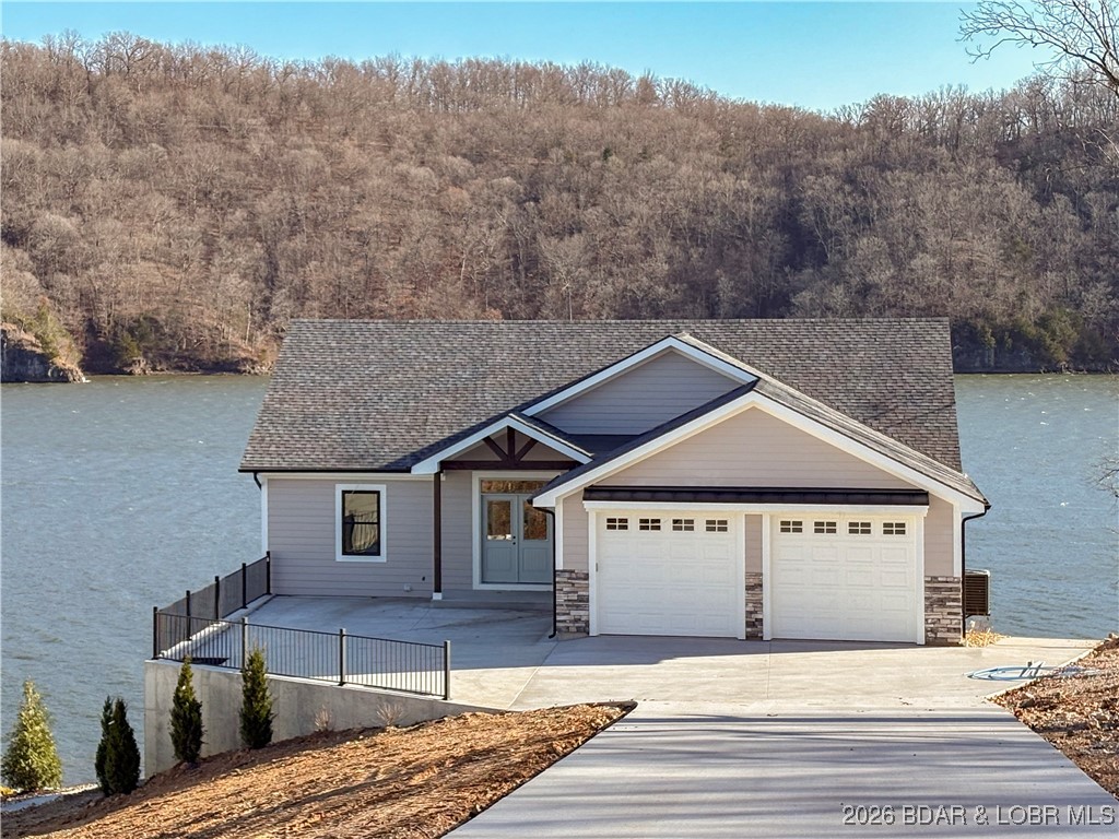 OPEN HOUSE SATURDAY and SUNDAY June 27-28 1-4pm New construction and Dock! Spectacular Views of the water! Gorgeous brand-new lakefront home featuring 4 bedrooms w/ 2 master suites, 3.5 baths, and nearly 3,000 sq. ft. of living space. Thoughtfully designed with an open-concept layout, this home is filled with natural light and showcases panoramic lake views from nearly every room. With 120 feet of waterfront, you’ll enjoy endless opportunities to relax and entertain outdoors on the low-maintenance composite decks or the covered deck—perfect for peaceful mornings and evenings overlooking the water. Truly a rare find on the lake! Dock has 2 boat slips 12x36, and 10x28, 2 wave runner slips, covered seating and uncovered swim area. This home also has a golf cart walkway from driveway to the dock with parking area.